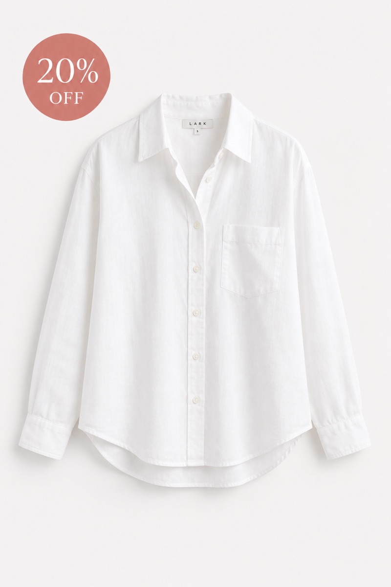 A white oversized shirt on a product page with a 20% off sale badge